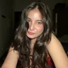 Aditi Kashyap with long dark hair, photographed indoors in low light