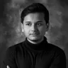 Sudarshan Kar in a turtleneck, black and white studio portrait